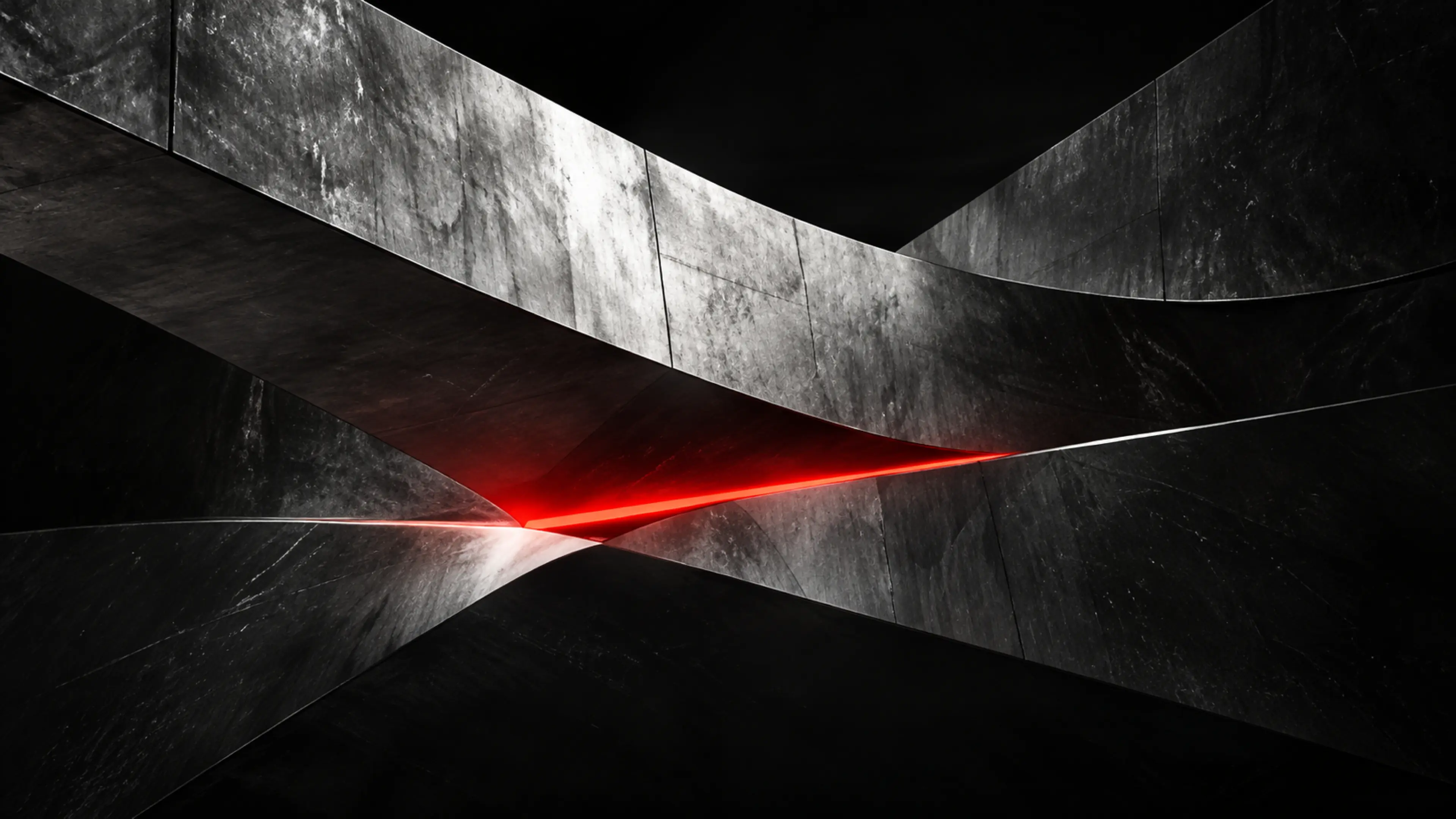 Des voiles de béton qui se croisent sur un trait rouge.